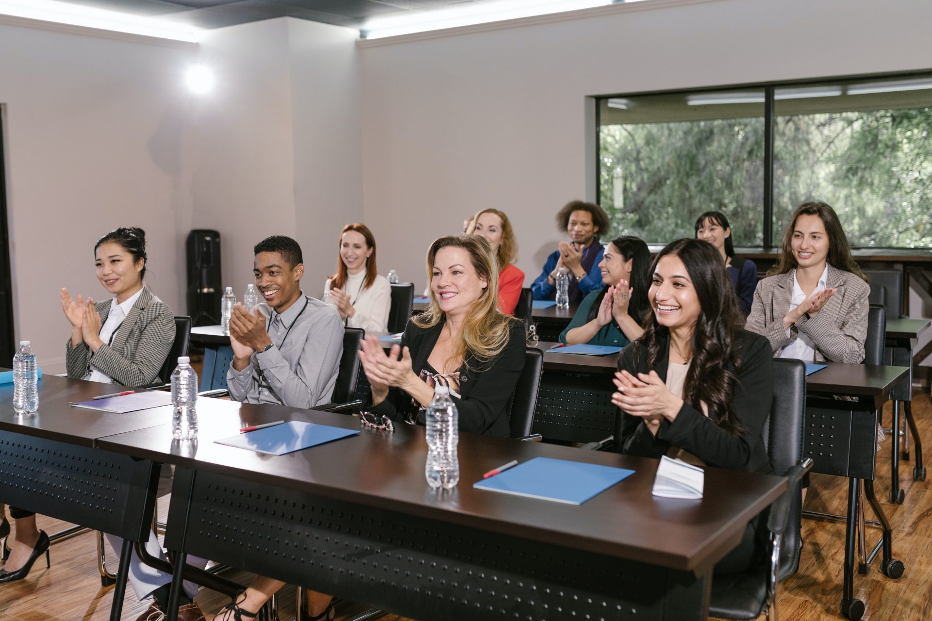 Photo by RODNAE Productions: https://www.pexels.com/photo/group-of-people-in-a-conference-room-clapping-7648476/